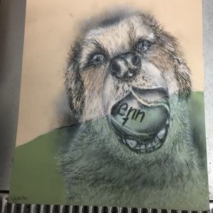 Charcoal drawing of a dog holding a tennis ball